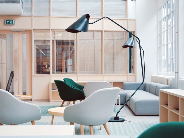Office lounge chairs beside open shelving